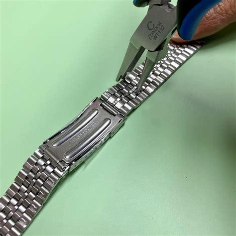 metal link watch band adjustment.